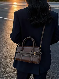Elegant brown leather handbag with contrast stitching for a retro autumnal look.