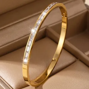 Elegant 18K gold-plated titanium steel bangle featuring rectangular baguette clear stones