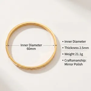 Detail of gold-plated titanium steel bangle with evil eye engraving and mirror polish finish