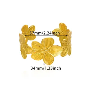 Detailed view of gold-toned flower cuff bracelet with 57mm width and 34mm flower size