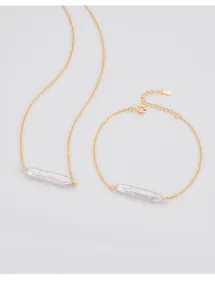 Detail of a 925 sterling silver gold necklace and bracelet with Baroque pearl bars.