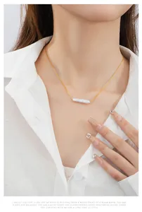Close-up of a Baroque pearl necklace in S925 sterling silver worn with a white shirt
