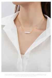 Close-up view of a gold-plated 925 sterling silver necklace with a Baroque pearl pendant.