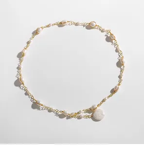 High-quality detailed shot of Baroque irregular pearl necklace with elegant gold wire wrapping