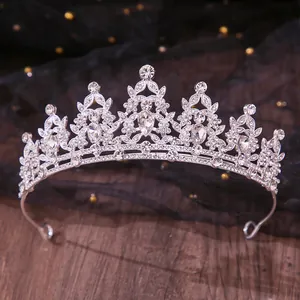 Close-up detail of a silver rhinestone bridal tiara with intricate floral patterns
