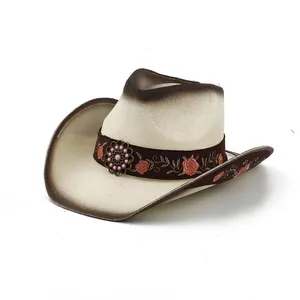 Detailed macro view of a summer woven straw cowboy hat with pink rose floral embroidery