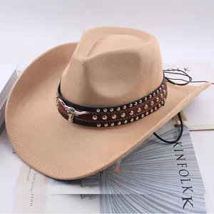 Close-up view of tan western cowboy hat with studded band and silver bull head emblem.