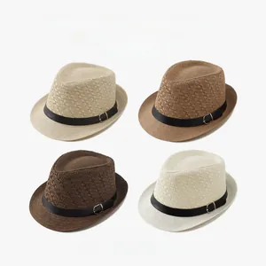 Detail view of four vintage straw fedora hats in varied colors with black decorative bands.