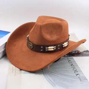 Detail of brown western cowboy hat with bull head emblem and decorative band.