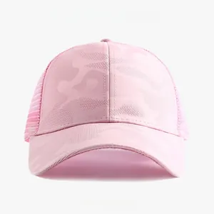 Close-up view of a pink camouflage trucker hat featuring breathable mesh panels