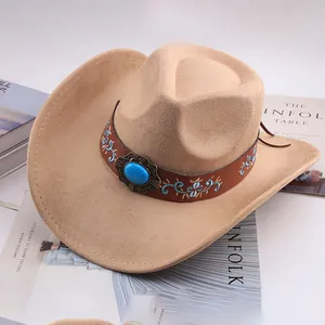 Close-up of a beige cowboy hat with an embroidered band and turquoise stone detail