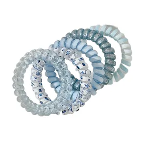 Lot de 6 élastiques à cheveux spirales bleus avec motifs floraux et paillettes scintillantes.