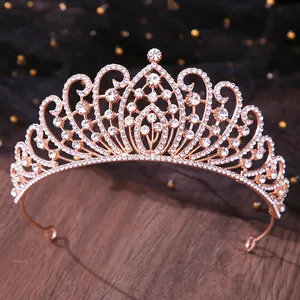 Close-up of elegant rose gold bridal tiara with sparkling crystal rhinestones on wood