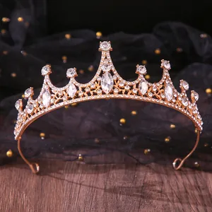Detailed close-up showing the intricate rhinestone patterns on a gold bridal crown tiara
