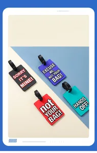 Macro detail of colorful PVC luggage tags featuring bold slogans and adjustable black straps