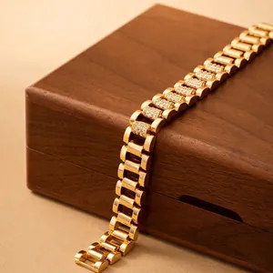 Detailed view of the gold-plated watch chain bracelet with zircon pavé accents.