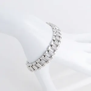 Close-up of a silver-toned copper watch-band bracelet encrusted with cubic zirconia