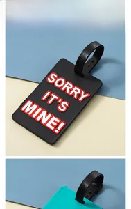 Close-up of durable PVC luggage tag with bold 'SORRY IT'S MINE!' text decoration