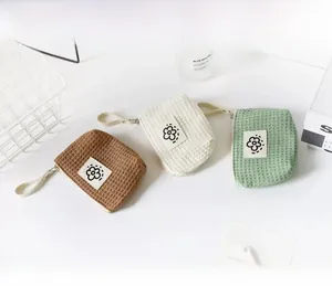 Waffle texture mini coin pouches in brown, white, and green for lipstick and earphones