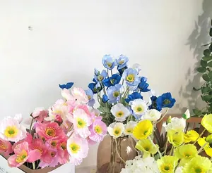 Detailed view of colorful artificial flocked Iceland poppy flowers in a glass vase