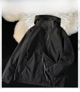 Close-up detail of a black waterproof outdoor windbreaker jacket with techwear functional style