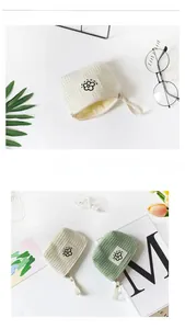 Close-up of waffle-texture mini cosmetic pouches for coin and headphone storage.