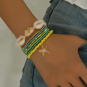 Detailed view of a 7-piece bohemian beach bracelet set with shells, beads and a starfish charm