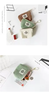 Detailed view of small waffle texture fabric pouch for coins and digital accessories