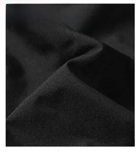 Macro close-up showing the durable waterproof outer fabric of the outdoor windbreaker jacket.