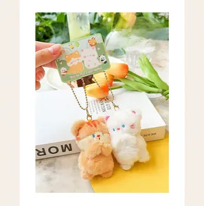 Detailed close-up of mini magnetic plush cat keychains with soft orange and white faux fur.