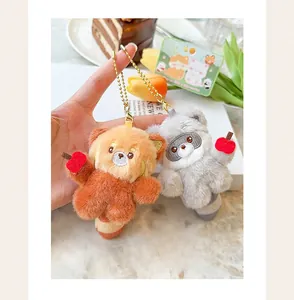 Detailed view of mini magnetic red panda and raccoon plush keychains.