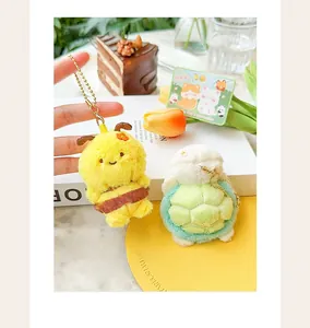 Close-up detail of cute plush animal magnetic keychains with bee and turtle designs.