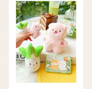 Close-up of mini magnetic pig and cabbage plush keychains in a cute lifestyle setting.