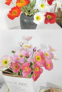 Detailed view of colorful artificial Iceland poppy flowers in a decorative paper bag