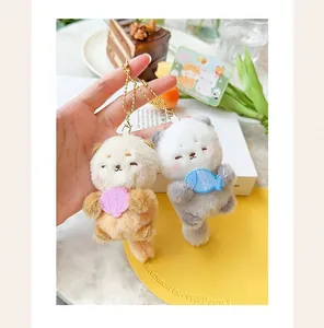 Detailed shot of two cute mini magnetic plush sea otter keychains for couples.