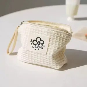 Compact waffle textured cream pouch with cute flower design for coins and earphones