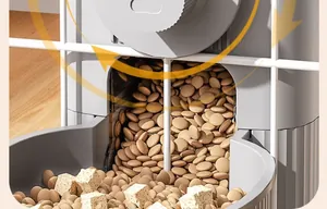 Detail view of an automatic pet feeder dispensing dry kibble and freeze-dried treats into a bowl