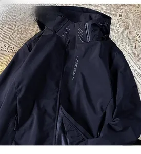 Close-up macro detail of black windproof functional outdoor jacket with explore text