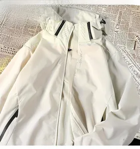 Close-up detail of a beige waterproof functional outdoor windbreaker jacket zipper