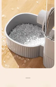 Close-up detail of a modern grey automatic pet feeder bowl with textured design