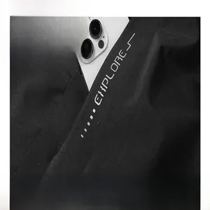 Detail view of black windproof functional outdoor jacket pocket with Explore print