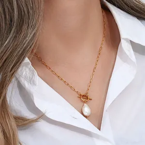 Detailed view of French Baroque pearl necklace with gold paperclip chain and toggle clasp.