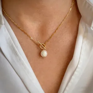 Close-up of a vintage baroque pearl necklace with a gold-tone toggle clasp.