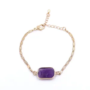 Close-up of a gold chain bracelet featuring a square purple amethyst gemstone.