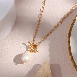 Close-up view of a Baroque pearl pendant necklace featuring a gold toggle clasp