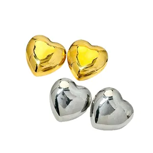 Minimalist polished 3D heart-shaped stud earrings in gold and silver stainless steel