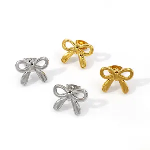 Nahaufnahme eleganter goldener und silberner Schleifenohrringe mit poliertem Finish