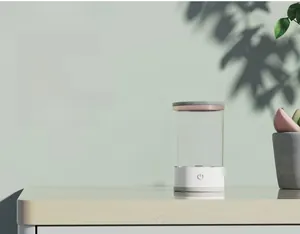 Close-up detail of a minimalist electric makeup brush cleaner standing on a clean office desk