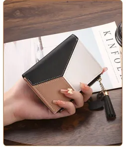 Close-up detail of a bifold leather wallet for women with tassel and bunny charm