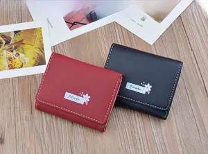 Minimalist women's short wallets in red and black with elegant flower embroidery detail.